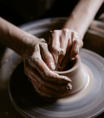 Hands shaping clay